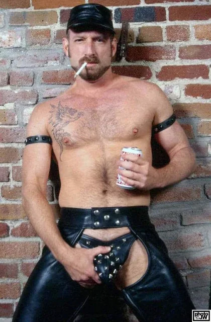 4/4 Leather daddy holding spiked leather thong gripping dick smoking a cig