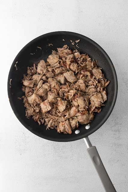 carnitas in a skillet after crisping.