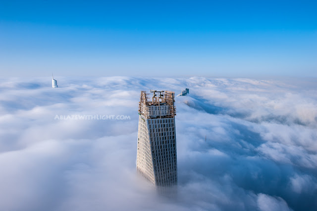 Photo of Infinity Tower's roof above the fog