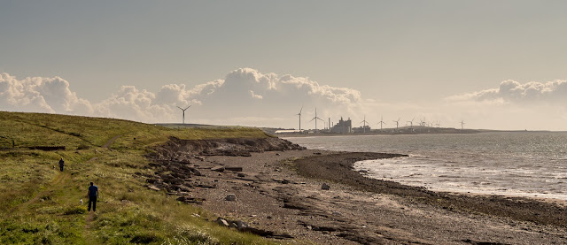 Photo of people walking along the coastal path towards Flimby