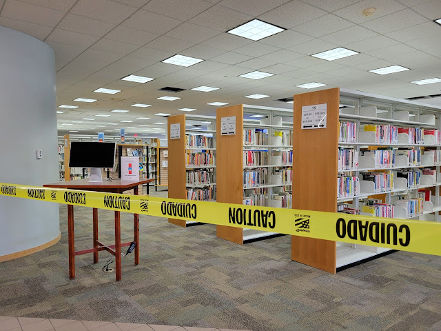 There is caution tape closing off a section of the Birmingham Public Library's 3rd floor to the public.