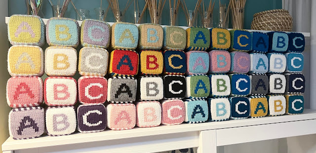 hand knit abc 123 foam blocks on a shelf in many colors