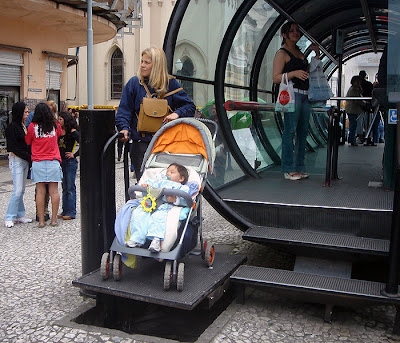 wheelchair lift being used by mom with stroller