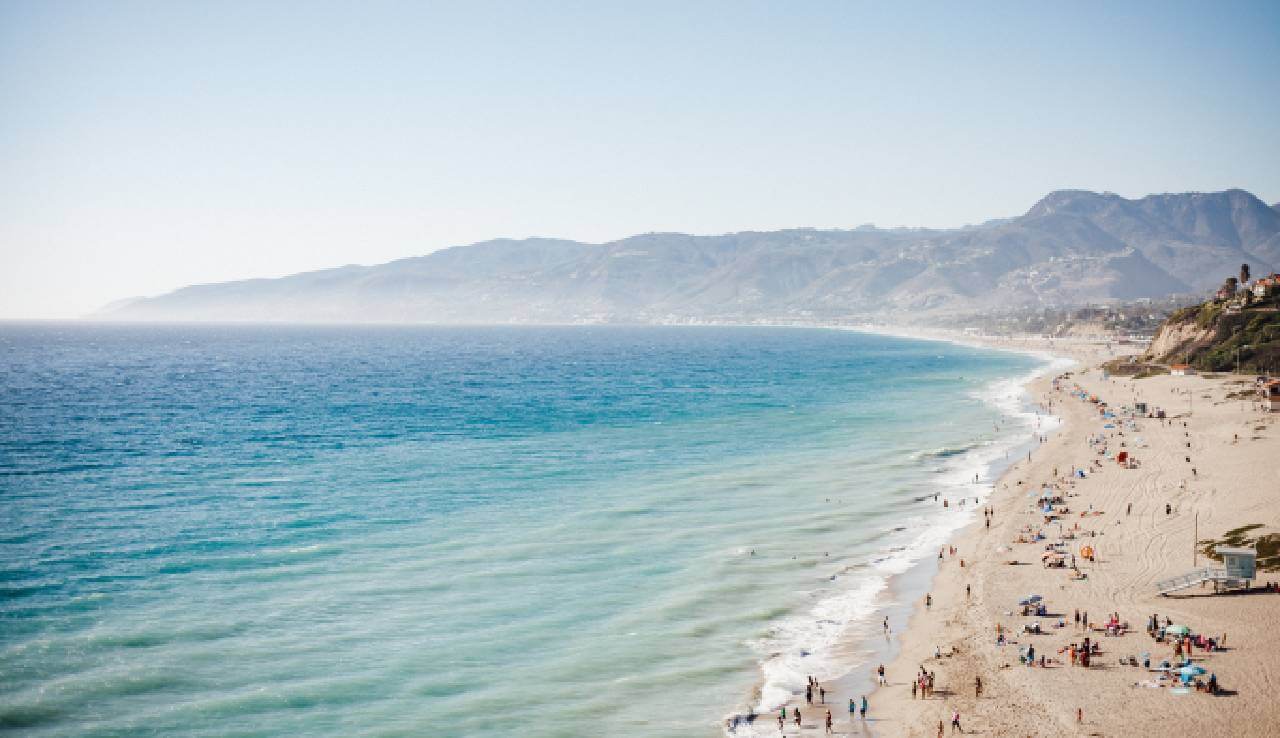 Explore the Beauty of Malibu, California: A Beachside Paradise - Located west of Los Angeles on the coast of southern California, Malibu is a popular beachside town known for its stunning beaches, picturesque coastline, and celebrity residents.  - With 21 miles of coastline along the Pacific Ocean, Malibu offers a touch of paradise for sun-loving beachgoers.    Seclusion and Celebrity Charm    - Despite its reputation as a star-magnet, Malibu maintains a secluded atmosphere, making it a preferred home or weekend retreat for many celebrities.     - The privacy of these stars is well-protected with gated areas, accessible only to invitees. However, walking below the high tide line allows visitors to enjoy the beaches in front of some famous homes.     - While some beaches are private, including a few nudist beaches, these are located in secluded areas. Exploring Malibu's beaches might offer unexpected encounters with the rich and famous.    Coastal Beauty and Highlights    - Malibu may not be known for its attractions or theme parks, but it offers some of the world's finest coastal views.     - The Malibu Pier, formerly damaged by a storm, has been restored and stands as a highlight of the area.     - Another notable spot is the Sierra Retreat, featuring beautiful gardens that add to the natural allure of the region.    Parking Considerations    - Malibu enforces strict parking laws, making it worthwhile to consider accommodations nearer to the beach if your main focus is enjoying the sun and surf.     - Leaving car hire for tourists who may not be aware of these regulations can simplify your visit and ensure a hassle-free experience.    The Ultimate Beach Vacation    - With its stunning ocean views and endless golden beaches, Malibu offers the perfect setting for a memorable beach vacation.     - The possibility of bronzing up next to a celebrity adds an exciting element to the overall experience, making Malibu a fantastic destination for relaxation and entertainment.