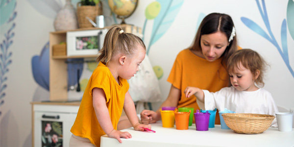 Stock photo of teacher working with young children