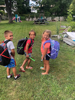 students with backpacks from community drive YMCA