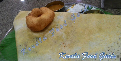 Image of Kerala dosa with chutneys and sambhar. Uzhunnu Vada on Top.