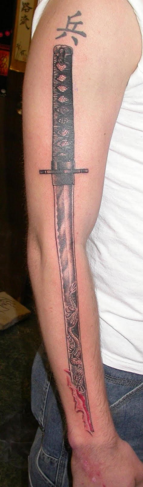 Long katana tattoo on arm.