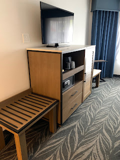 room tv, dresser and fridge