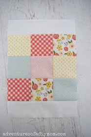 white border along the top and bottom of a nine patch quilt block