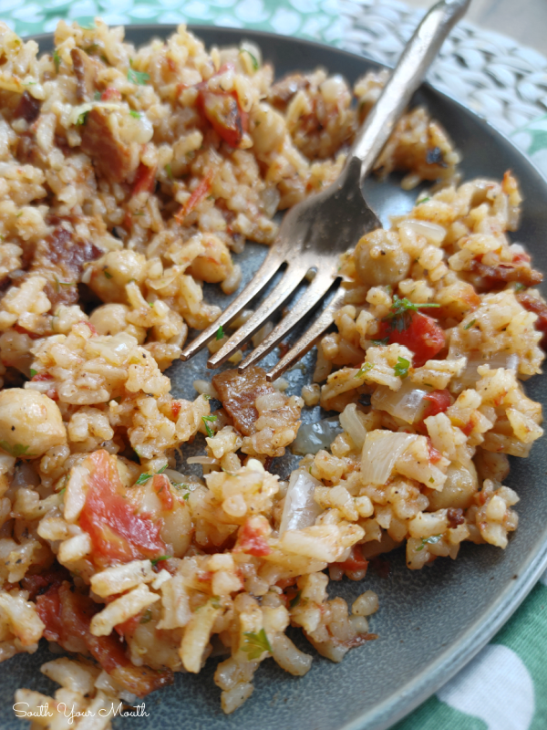 Mediterranean Chickpea Rice - A hearty rice recipe with chickpeas (garbanzo beans) flavored with bacon, tomatoes, onion and garlic perfect served on the side or as a main dish that easily converts to a meatless meal.