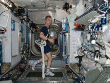 Bob Thirsk (Canadian Space Agency) exercises with the Glenn Harness aboard the International Space Station during ISS Expedition 20/21