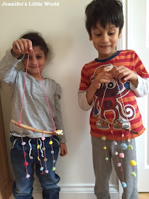 Making a simple stick mobile with buttons and pom poms