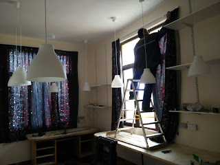 Bekir hanging the curtains