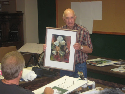 Artist and teacher Osral Allred shows one of his paintings at a workshop sponsored by the Southern Utah Watercolor Society in St. George, UT