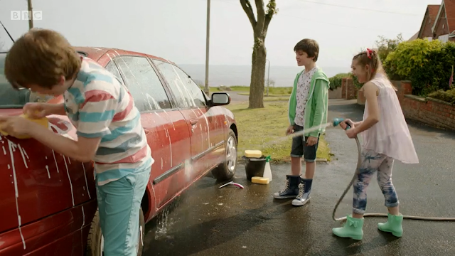 Three children washing a car on Sea Cliff Road, Scarborough. From All at Sea Series 1 Episode 6.