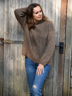 Tatsiana  is modelling in knitted sweater, made with DK weight yarn with cables at front