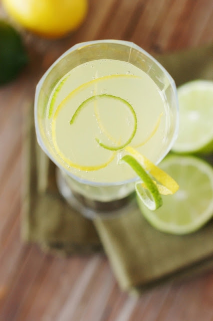 Sparkling Limoncello Cooler Garnished with Lemon and Lime Zest Image