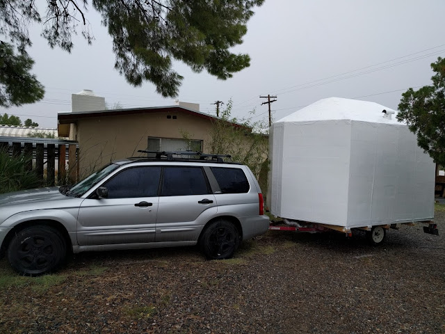 A large white shape attached to a silver car shape.