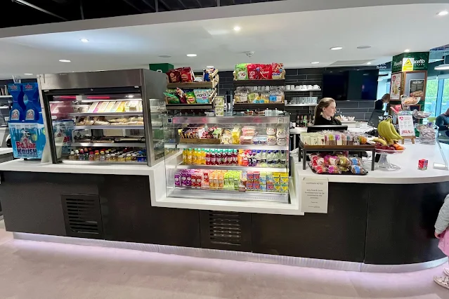 The counter at a cafe showing food and drink