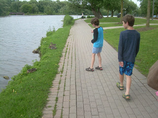 The boys looking at ducks on the bank of the Avon River.
