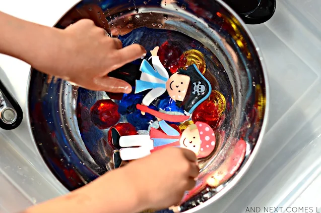 Two foam pirates in water sensory bin