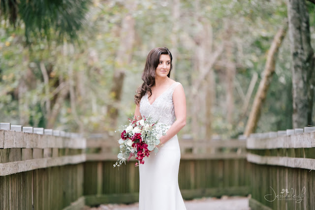 bride in wedding dress and red bouquet