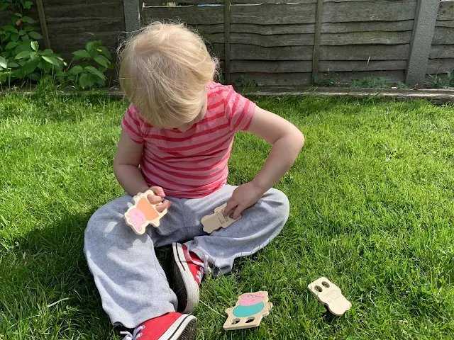Toddler playing with Peppa Pig Wooden Finger Puppets