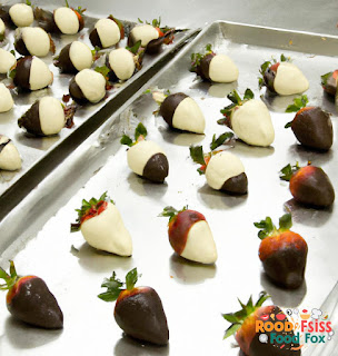 Image of chocolate covered strawberries on a lined baking sheet.