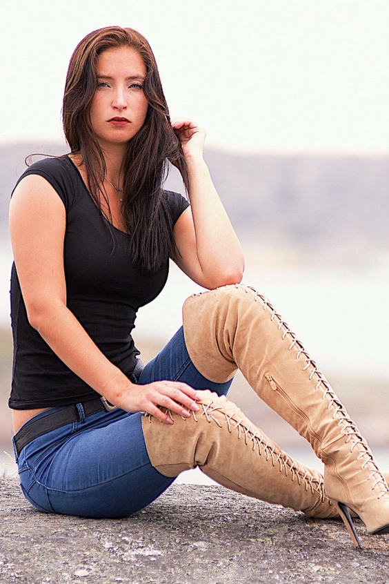 Cute woman wearing jeans and laced OTK boots