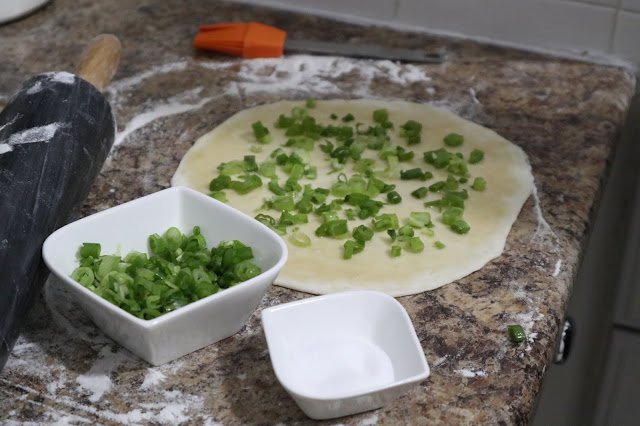 green onion cake flattened with sesame oil and green onion sprinkled on top. 