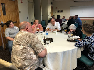 A group of individuals reflecting on their assignment during a time of group work.