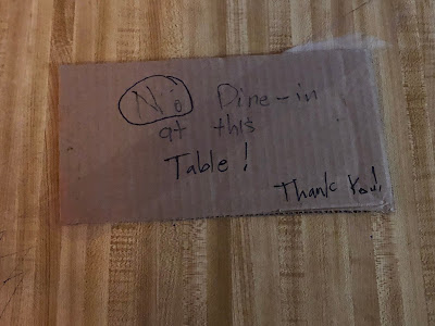 Sign on table: "No dine-in at this table."