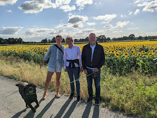Fran, Brigitte, Jens, and Louie in front of a sunflower field