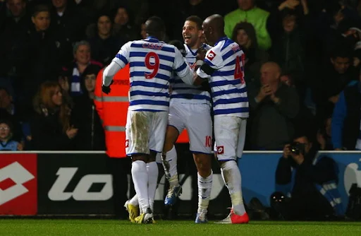 QPR player Adel Taarabt celebrates with his teammates after scoring his second goal against Fulham