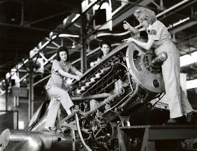 World War II photo of 3 women repairing an aircraft engine
