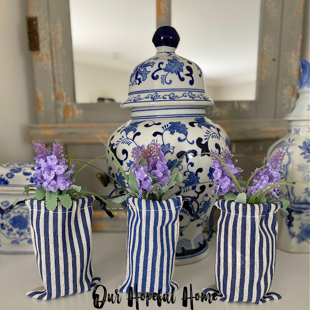 ginger jar mantel decor with blue and white striped ticking gift bags