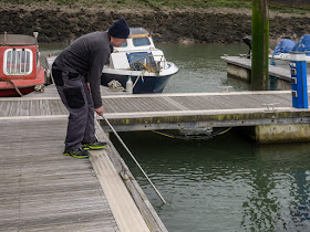 PHoto of Phil scooping out some of the fish with his landing net