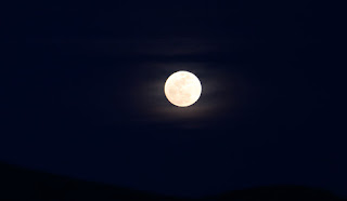 Moon glowing through the haze