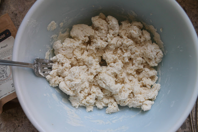 The dough coming together in large lumps.