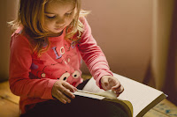 young child reading boook