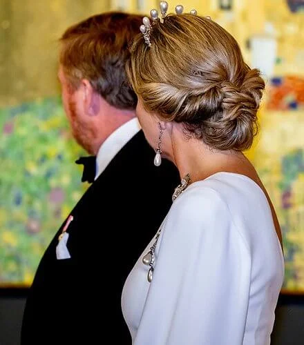 Queen Maxima wore a white one-shoulder stretch cady gown by Stella McCartney. Antique pearl tiara, earrings and brooch