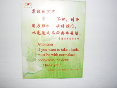 a sign on a door with Chinese characters followed by semi-English ATTONTION if you want to take a bath, must be with normalaze open/close the door. Thank you!