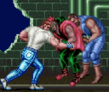 Final Fight shows guy in white t-shirt and blue jeans and also shows him punching two guys which look like punk style of guys from the 1990s time period wearing green and blue and red clothing with the guy with pink hearing in pain after being punched in street with part of the wall missing from it and also green pipes.png