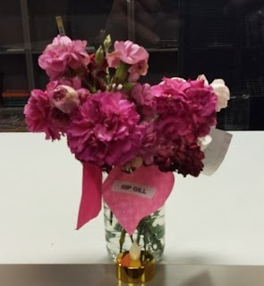pink carnations and a "RIP GILL" card