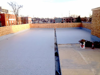 Installation of Duradek vinyl membrane on roof deck.