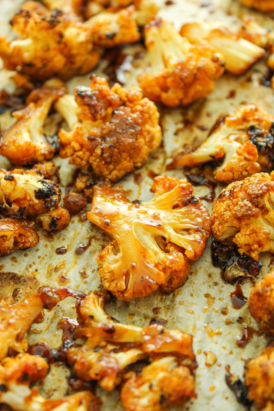 Cauliflower florets are tossed in an irresistible sweet and spicy marinade and baked until tender.