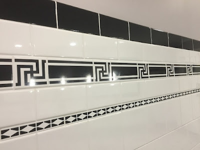 Black swastikas in the wall tiling of a bathroom in Brisbane City Hall.