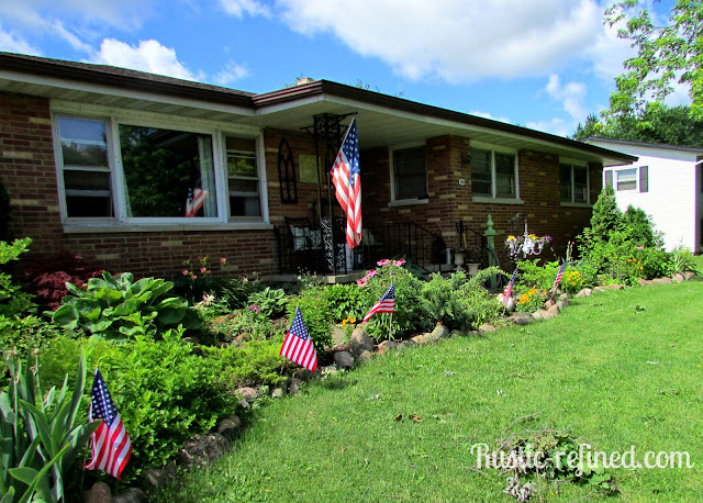 Touring flowerbeds in the front & backyard to see tons of flowers, bushes and tree's. 