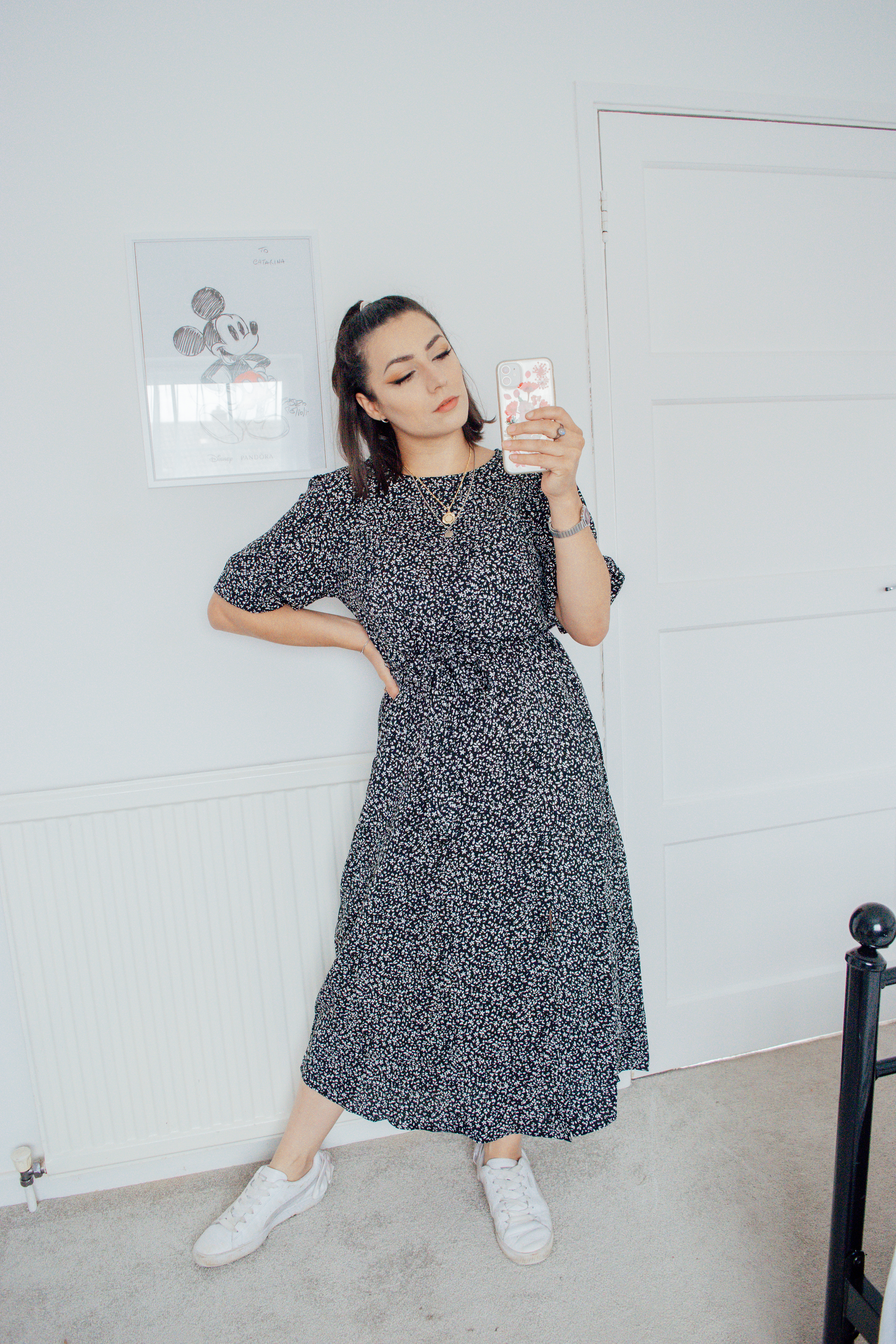 Girl wearing a black floral midi dress